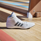 Side profile of Adidas men’s wrestling shoes showing breathable mesh upper and reinforced overlays for support.