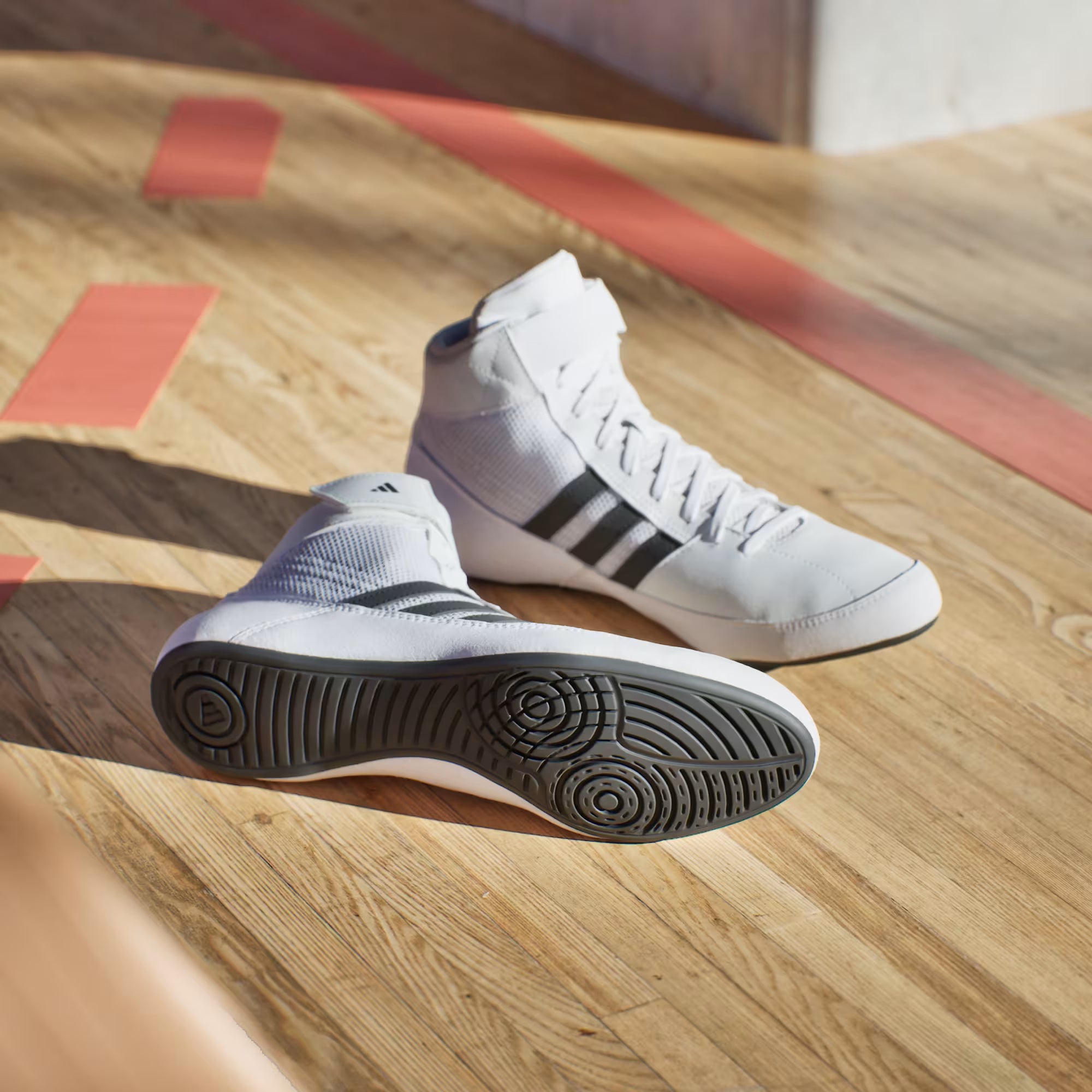 Close-up of Adidas wrestling shoes with breathable air mesh construction for ventilation and comfort.