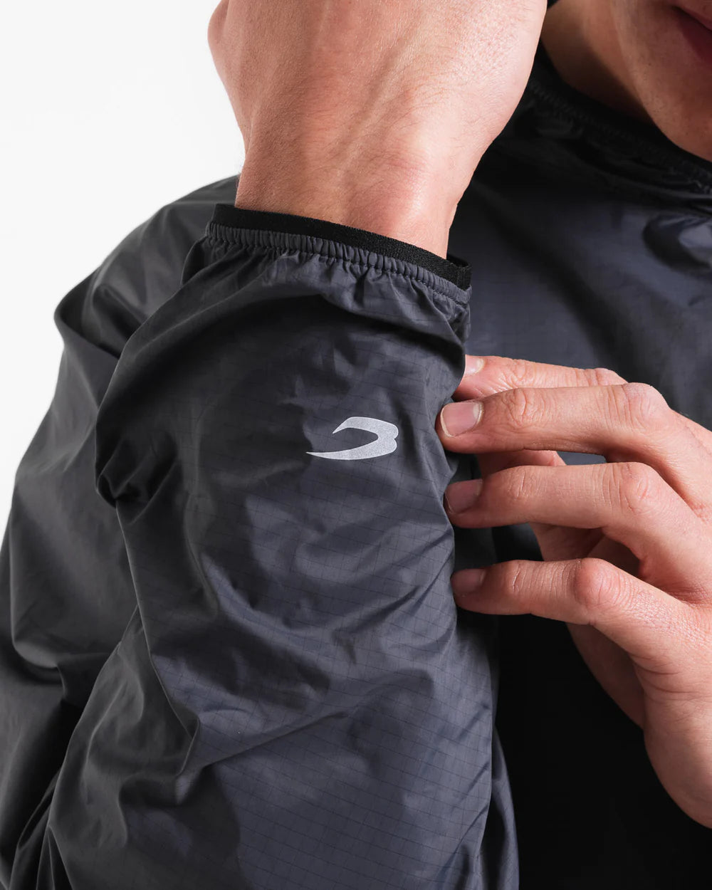 Reflective Strike logo cuff detail on Boxraw Genaro Oversized Windbreaker Hoodie Black