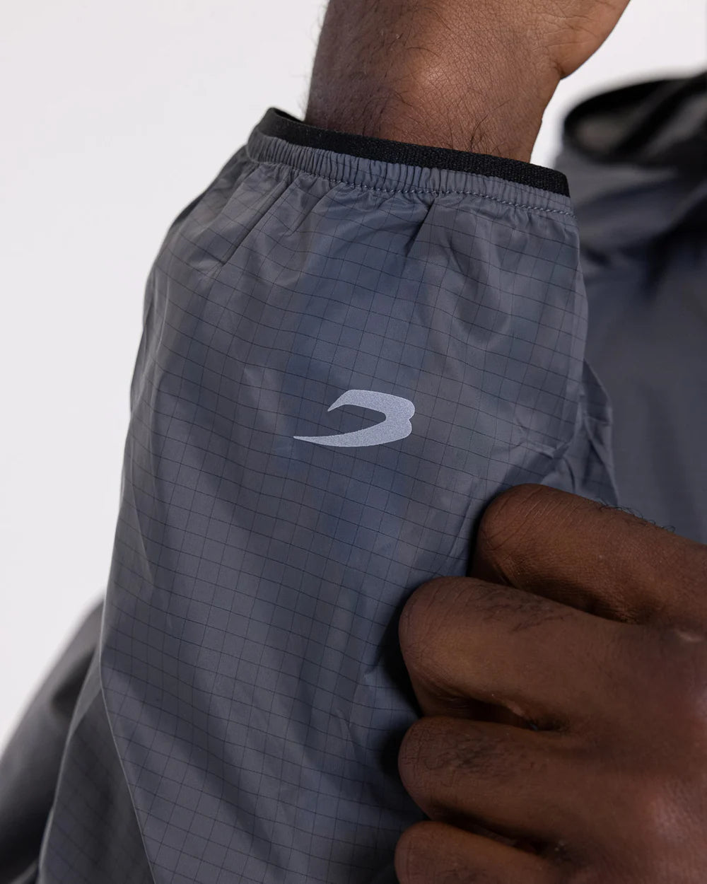 Reflective Strike logo cuff close-up on Boxraw Genaro Zip Up Windbreaker Charcoal