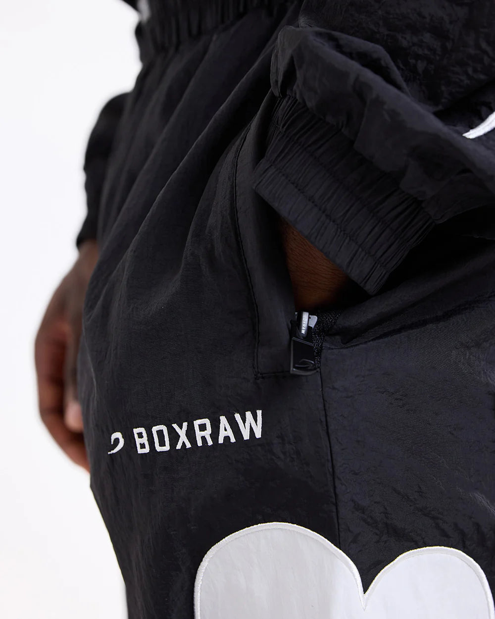 Side zipped pocket close-up on Boxraw Tunero Track Bottoms Black