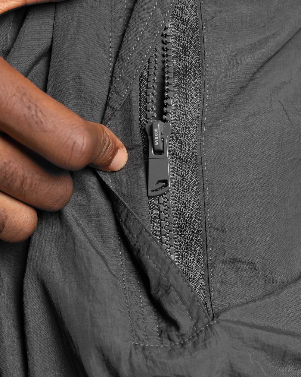 Side zip pocket and inside jacket zip pocket detail on Boxraw Tunero Track Jacket Grey