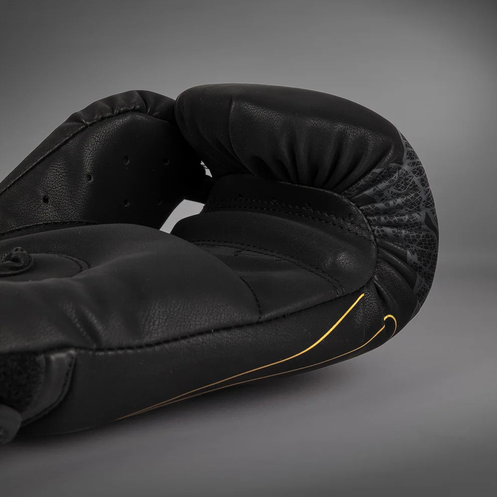 Palm-side view of Black/Silver/Gold Venum Serpenti Boxing Gloves showing gold graphics and the inner glove profiles