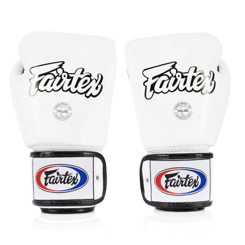 Side view of Fairtex BGV15 white boxing gloves showing contoured padding and double wrist strap.