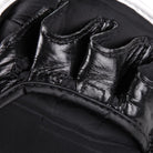 Side view of Fairtex BGV15 MMA gloves showing contoured padding and double wrist strap.