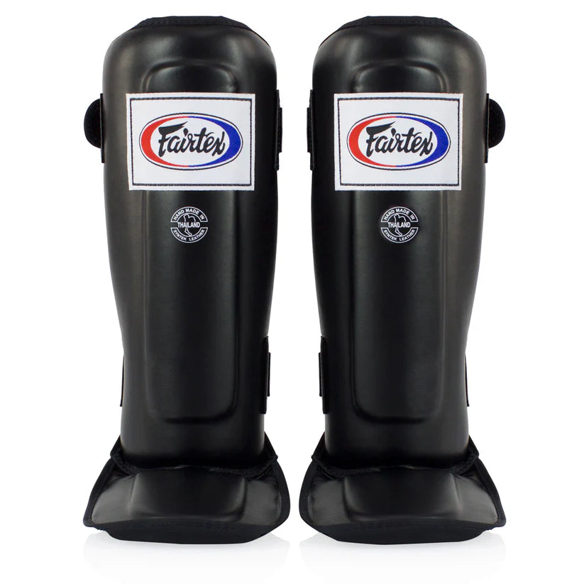 Fairtex shin guards for Muay Thai, MMA, and kickboxing with triple-layer foam protection.
