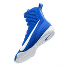 Boxer wearing Nike Machomai 3 blue white boxing shoes training inside a boxing ring.