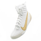 Boxer wearing Nike Machomai 3 white and gold boxing shoes during training session in the ring.