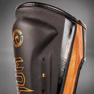 Venum Elite Evo shin protectors with strong hook-and-loop fasteners for secure fit.