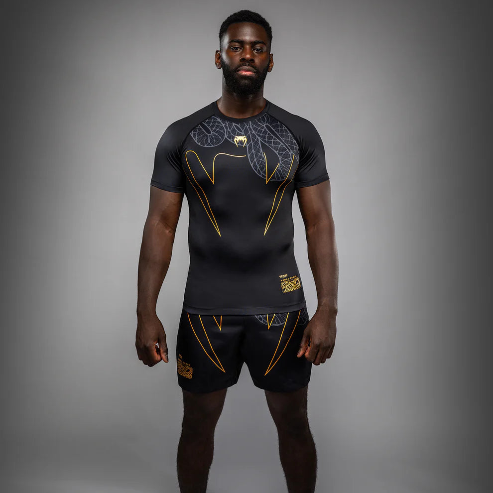 Venum Serpenti Short Sleeve Rashguard Black Silver Gold front view showing technical MMA rash guard design