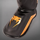 Venum Elite Evo kickboxing shin guards with reinforced tibia and instep padding.