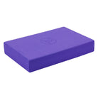 Angled view of purple Yoga-Mad yoga block showing chamfered edges and soft surface texture for comfort.