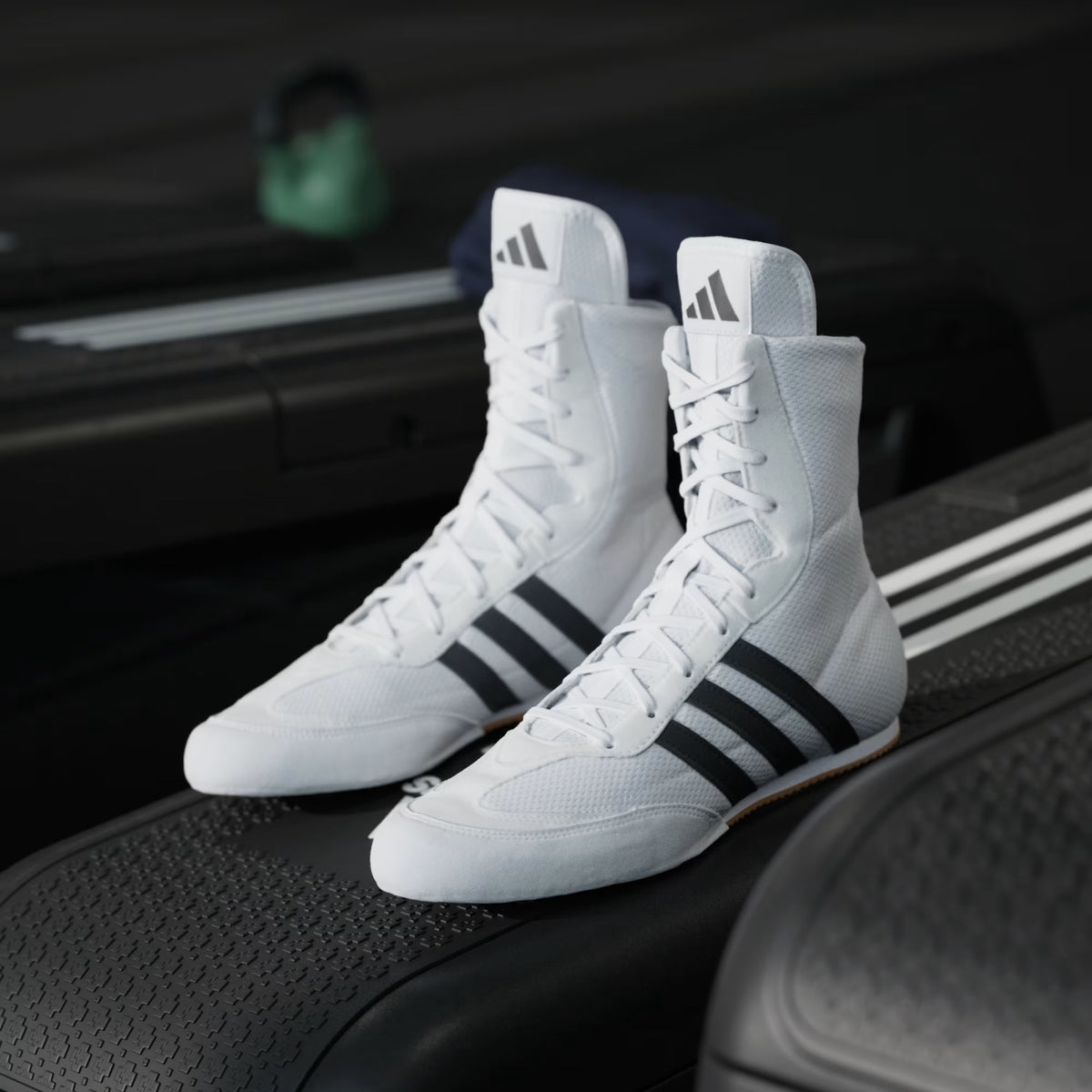 Front three-quarter view of adidas Box Hog 2 White boxing shoes showing the lace-up mid-cut design