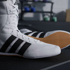 Lifestyle close-up of adidas Box Hog Classic Cloud White/Core Black boxing shoes showing the foldable collar and classic white design
