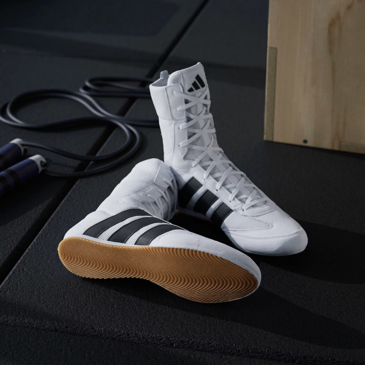 Model wearing adidas Box Hog Classic boxing shoes in Cloud White/Core Black during pad work