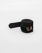 Patent-pending hook and loop thumb loop close-up on Boxraw 4.5m Sparring Club Hand Wraps Black Orange