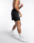 Side view of Boxraw Tunero 2-in-1 Shorts Black showing Double Strike design and split hem