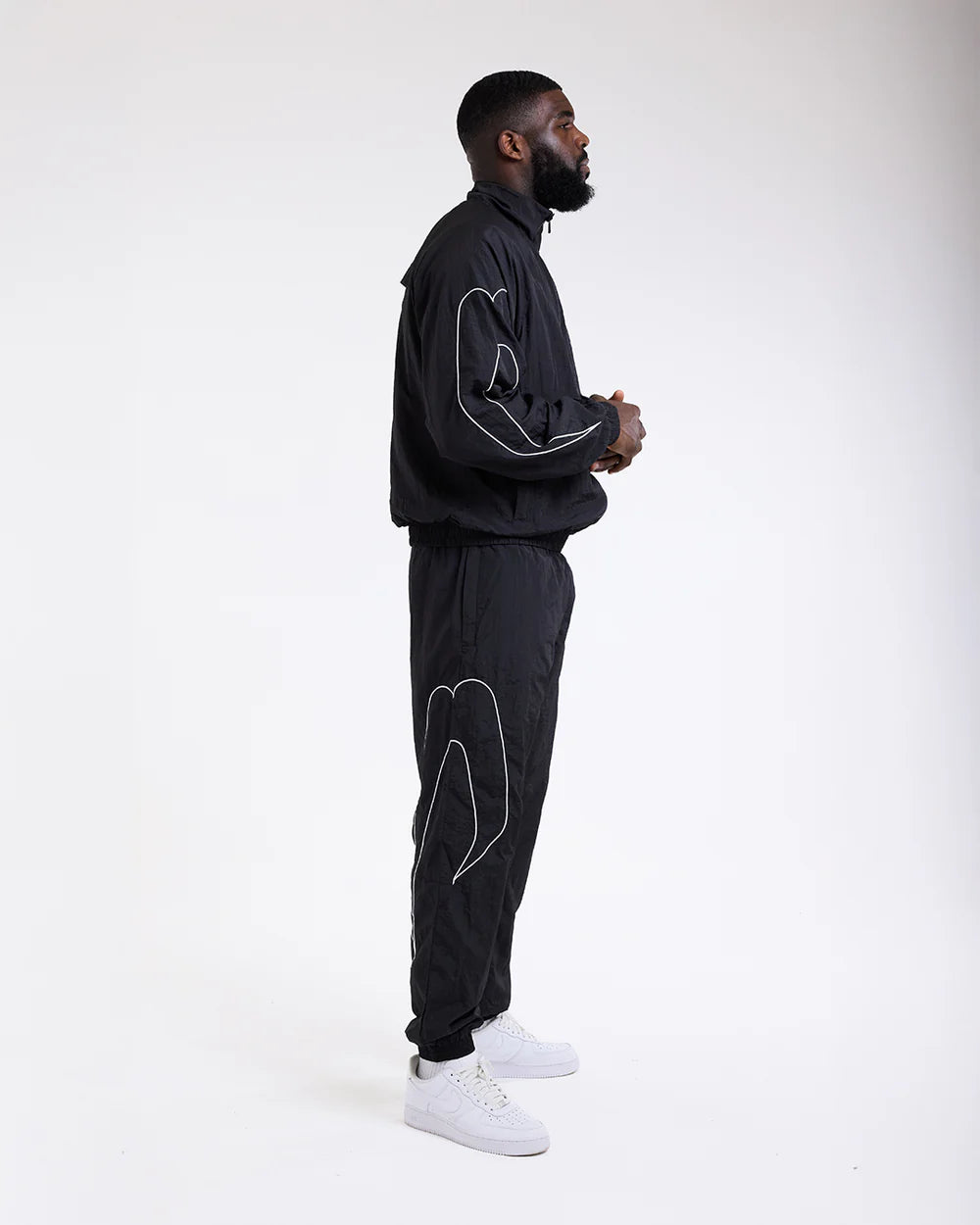 Side view of Boxraw Tunero Track Bottoms Black showing Double Strike design