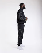 Side view of Boxraw Tunero Track Bottoms Black showing Double Strike design