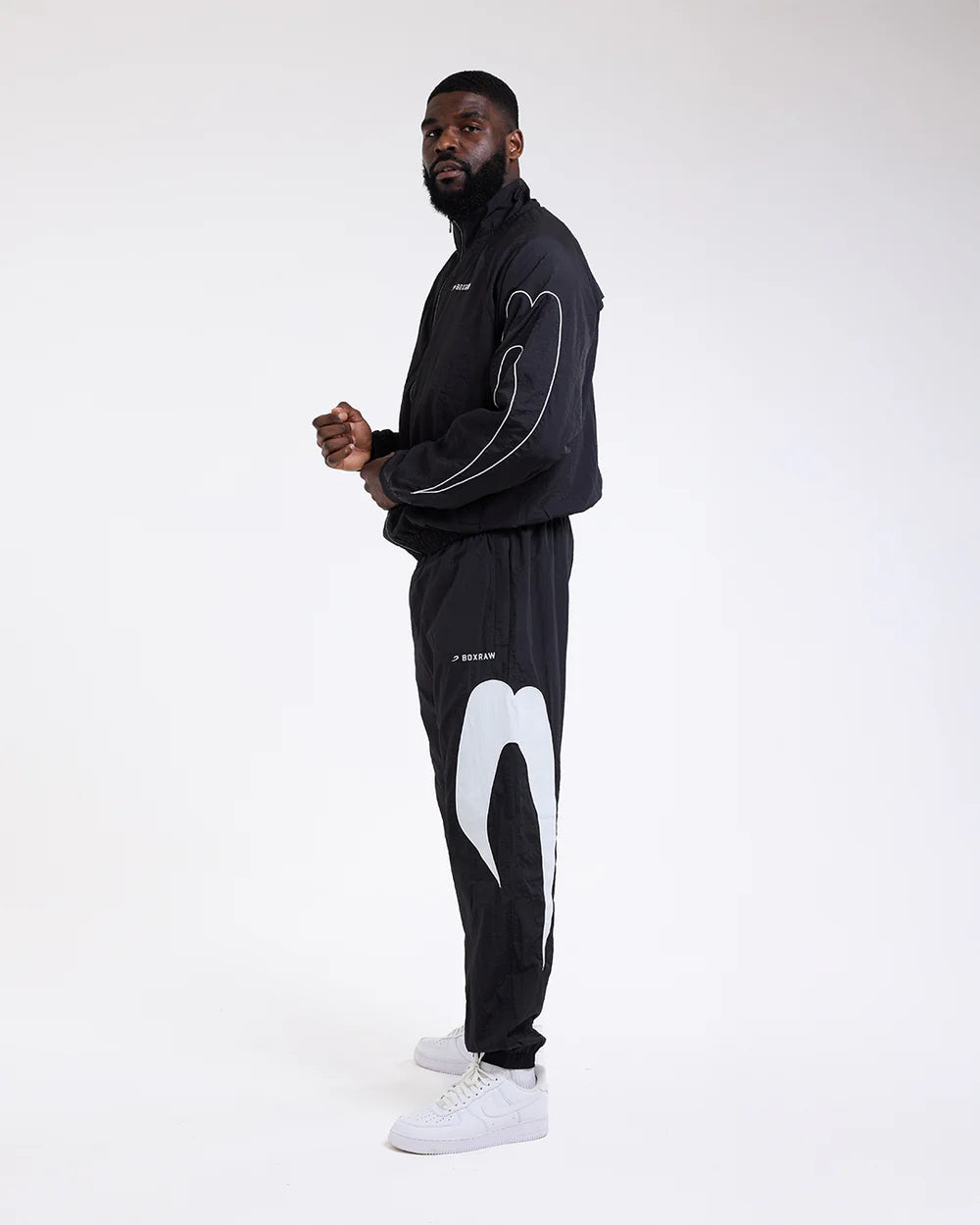 Side view 2 of Boxraw Tunero Track Bottoms Black showing Double Strike design