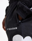 Side zipped pocket close-up on Boxraw Tunero Track Bottoms Black