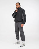 Side view of Boxraw Tunero Track Bottoms Charcoal showing Double Strike design and relaxed fit