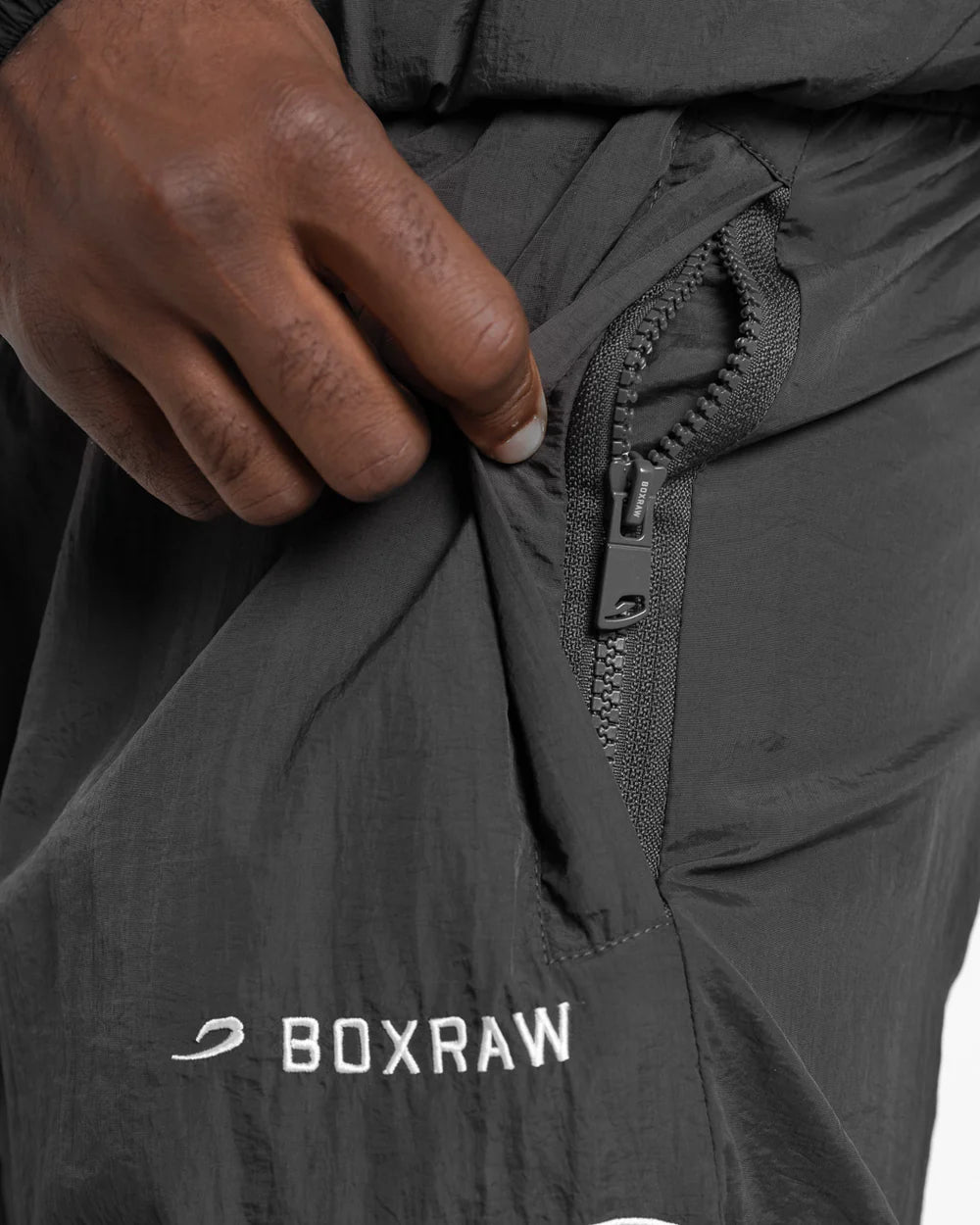 Side zipped pocket close-up on Boxraw Tunero Track Bottoms Grey