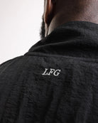 Embroidered LFG logo and sleeve Strike logo close-up on Boxraw Tunero Track Jacket