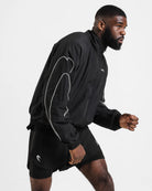 Side view of Boxraw Tunero Track Jacket showing oversized fit and Double Strike sleeve design