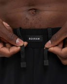 Rubber Strike logo lace ends close-up on Boxraw Valdes Shorts Black