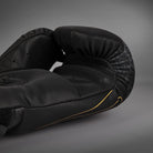 Palm-side view of Black/Silver/Gold Venum Serpenti Boxing Gloves showing gold graphics and the inner glove profiles