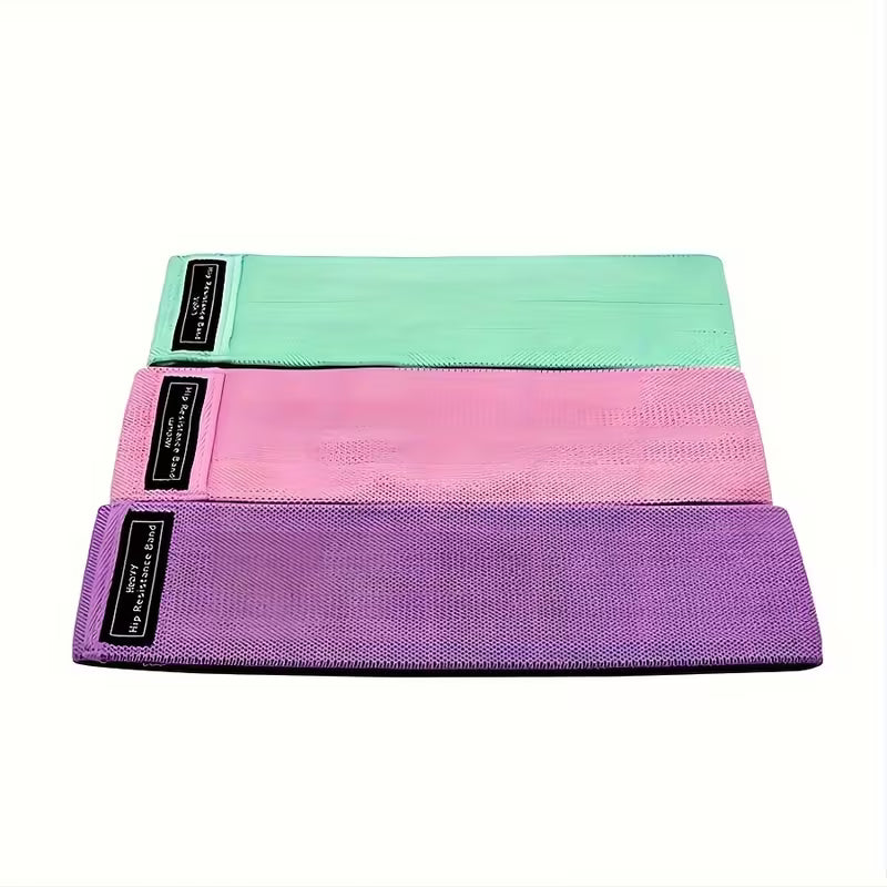 Fabric resistance bands set with three loop bands and carry bag on white background