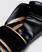Athlete wearing Fly Superloop Pro X2 boxing gloves in black and gold during training session