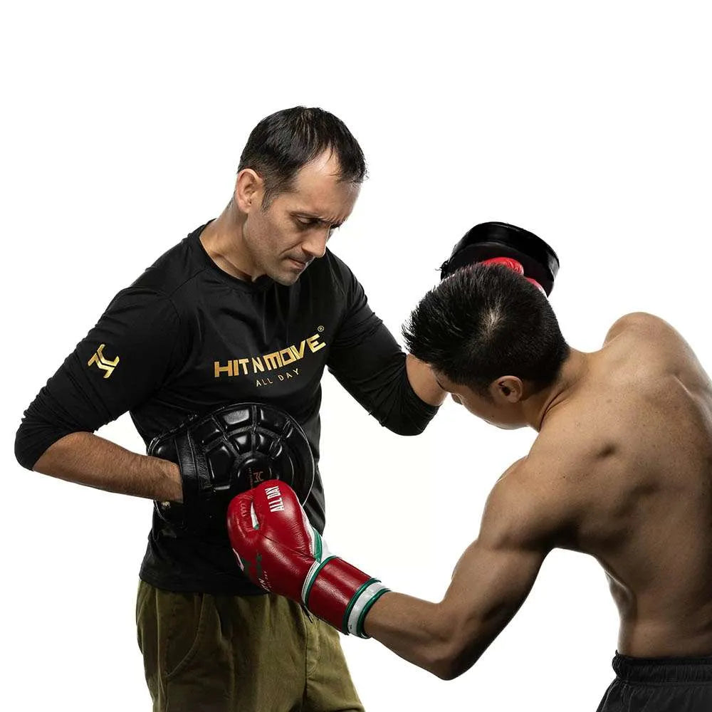boxing coach using Turtle Mitts for body shot drills in gym