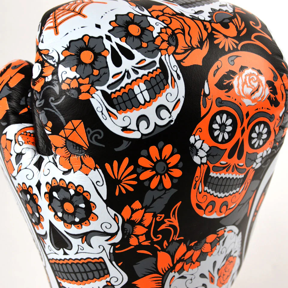 side view of Twins Calaveras orange gloves showing skull design and cuff