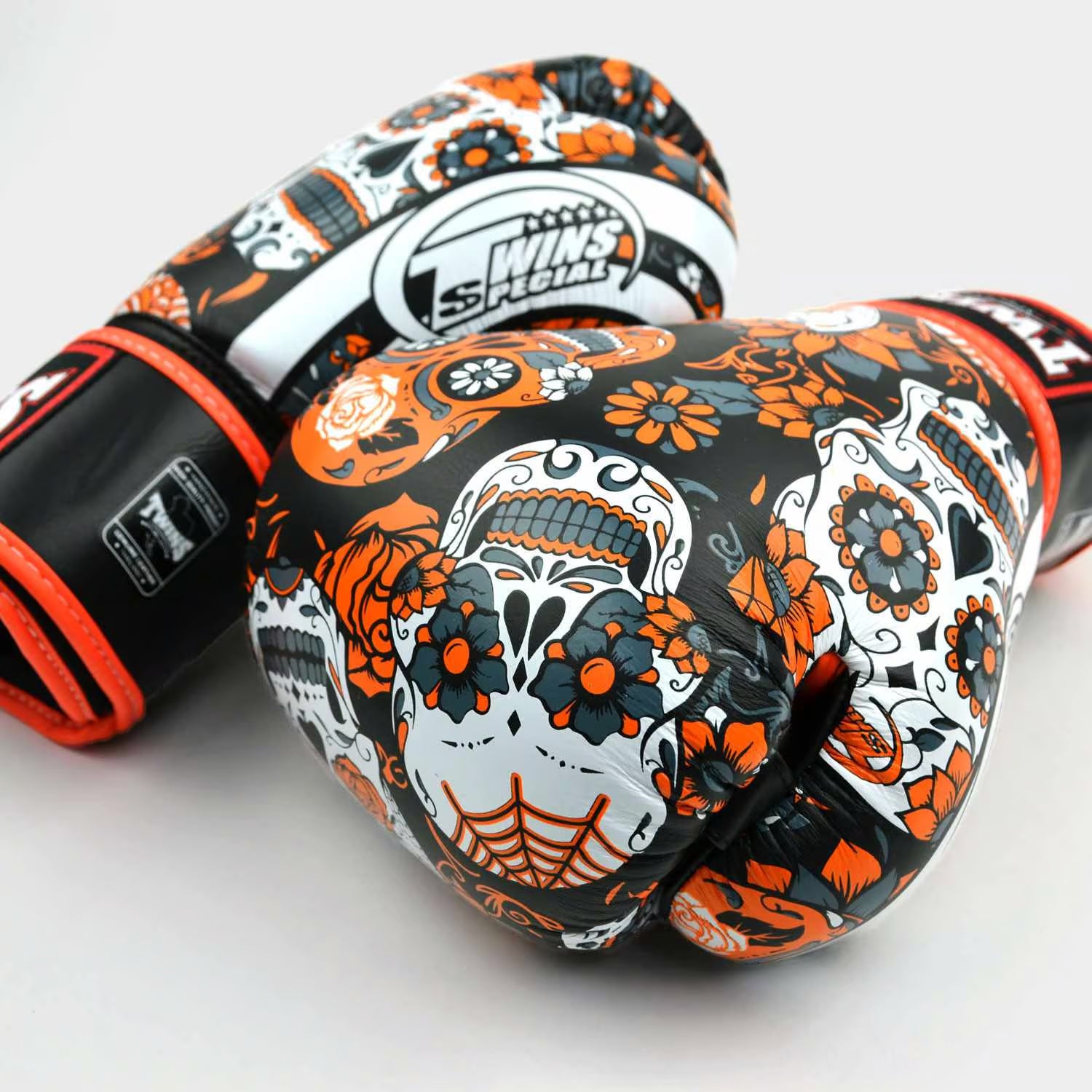 Twins Calaveras orange boxing gloves used in Muay Thai training session