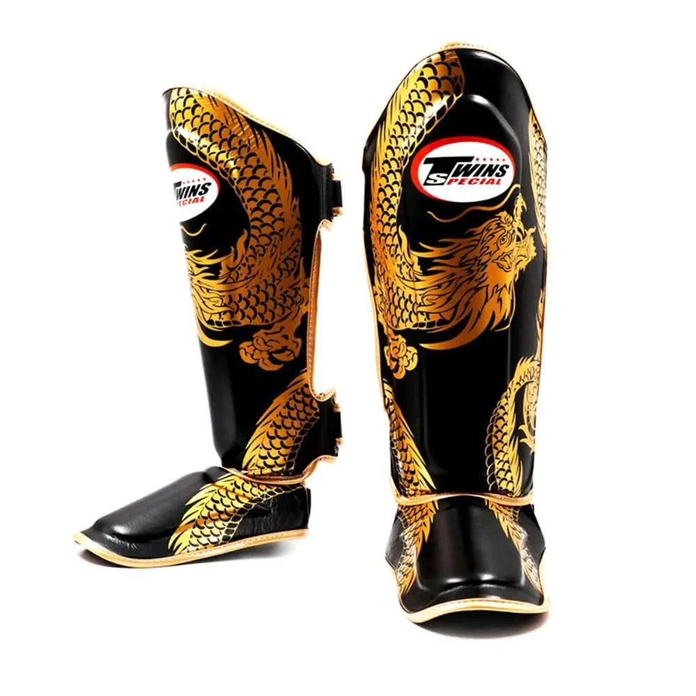 Pair of Twins Double Padded Leather Shin Guards in Dragon Black/Gold showing the gold dragon artwork, Twins branding and instep sections