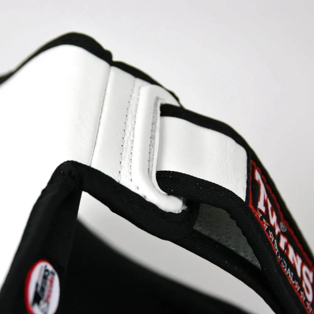 Angled product view of Twins Double Padded Leather Shin Guards in White showing the curved shin and foot profile