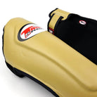 Twins Latte Muay Thai shin guards used during sparring training in a combat sports gym