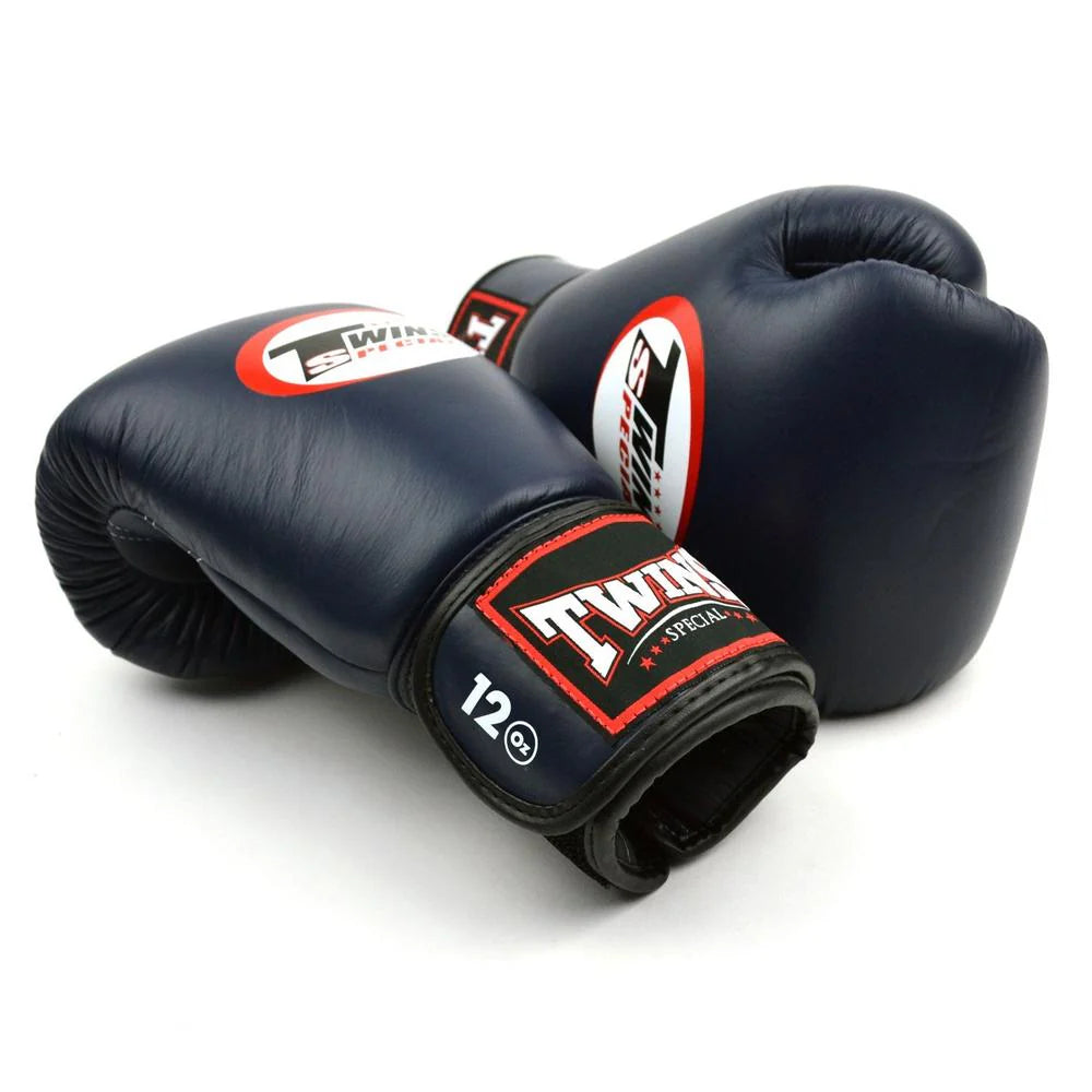 Side profile of Twins Special BGVL4 Navy Boxing Gloves showing ergonomic shape and tight-fit hand compartment.