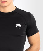 Athlete wearing Venum Contender short sleeve rashguard during training