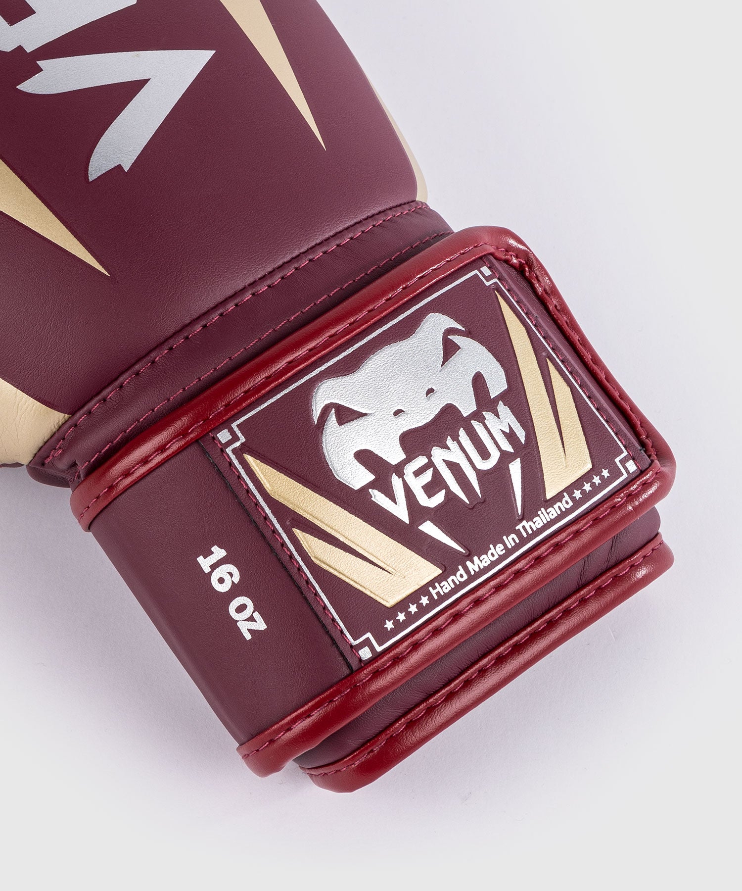 Venum Elite Burgundy Gold boxing gloves worn during boxing training session