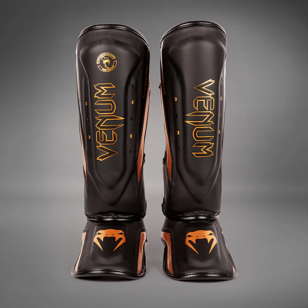 Venum Elite Evo shin guards for Muay Thai, MMA, and kickboxing training.