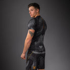 Black Grey Gold Matupa graphic detail close-up on Venum short sleeve rashguard