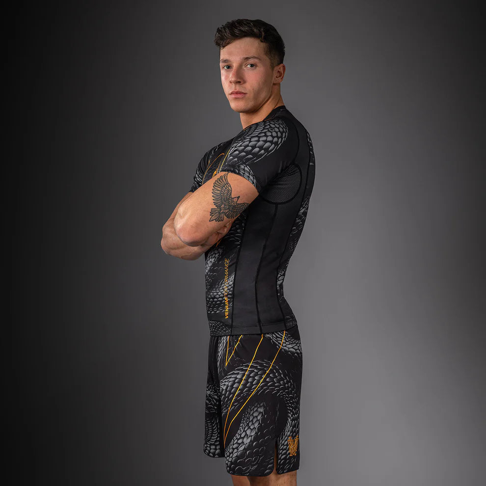 Side view of Venum Matupa Short Sleeve Rashguard Black Grey Gold showing tight short sleeve fit second