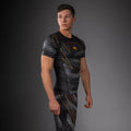 Side view of Venum Matupa Short Sleeve Rashguard Black Grey Gold showing tight short sleeve fit