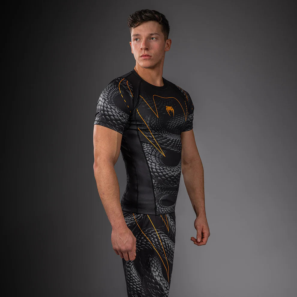 Side view of Venum Matupa Short Sleeve Rashguard Black Grey Gold showing tight short sleeve fit