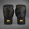 Front view of Venum Serpenti Boxing Gloves in Black/Silver/Gold with serpent graphics, Venum branding and gold wrist logos