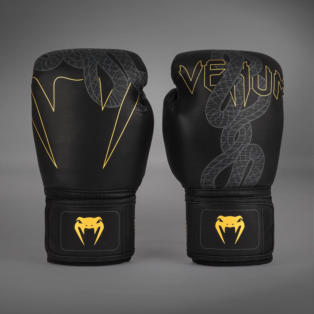 Front view of Venum Serpenti Boxing Gloves in Black/Silver/Gold with serpent graphics, Venum branding and gold wrist logos