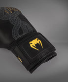 Close-up of the palm and attached thumb on a Black/Silver/Gold Venum Serpenti Boxing Glove showing the stitched inner construction